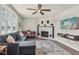 Living room with sectional sofa, fireplace, and hardwood floors at 4155 Senour Rd, Indianapolis, IN 46239