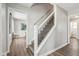 Modern staircase with white railing and wood steps at 4155 Senour Rd, Indianapolis, IN 46239