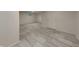 Large basement with light gray faux-wood plank flooring, white walls, and a window for natural light at 5131 Nicodemus Dr, Plainfield, IN 46168
