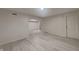 View of a large, finished basement showcasing light gray faux-wood plank flooring and neutral paint at 5131 Nicodemus Dr, Plainfield, IN 46168