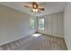 Bright bedroom with carpeted floor, ceiling fan, and two windows at 5131 Nicodemus Dr, Plainfield, IN 46168