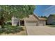 Brick house with 3-car garage and landscaped lawn at 5131 Nicodemus Dr, Plainfield, IN 46168