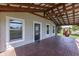 Spacious covered porch with brick flooring, ceiling fan, and cozy seating, ideal for outdoor relaxation at 5750 W 300 N Rd, Bargersville, IN 46106