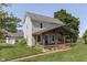 Two-story home with covered porch, decorative columns, and a brick walkway enhances the curb appeal at 5750 W 300 N Rd, Bargersville, IN 46106