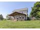 Inviting two-story home with a cozy covered porch featuring hanging chairs, perfect for enjoying the outdoors at 5750 W 300 N Rd, Bargersville, IN 46106
