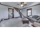 Cozy living room featuring hardwood floors, a comfortable sofa, and a view into the kitchen at 5750 W 300 N Rd, Bargersville, IN 46106
