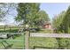 Fenced yard and pasture featuring a red shed, mature trees, and open fields at 5750 W 300 N Rd, Bargersville, IN 46106