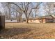 Large backyard with mature trees and shed at 6847 W 15Th St, Indianapolis, IN 46214