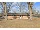 House backyard with large trees and grass at 6847 W 15Th St, Indianapolis, IN 46214
