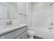This bathroom features a quartz countertop, grey cabinets, and a standard shower/tub combo at 7300 Legends Way, Whitestown, IN 46052
