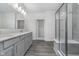 Bathroom features a quartz countertop, grey cabinets, and a glass enclosed shower at 7300 Legends Way, Whitestown, IN 46052