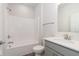 Clean bathroom with tub/shower combo and grey vanity at 7300 Legends Way, Whitestown, IN 46052