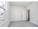 Bright bedroom with neutral walls and carpet and a window overlooking the neighborhood at 7300 Legends Way, Whitestown, IN 46052