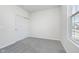 This room features neutral walls and carpet with a closet and window with neighborhood view at 7300 Legends Way, Whitestown, IN 46052