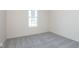 Bright bedroom with grey carpet and large window at 7300 Legends Way, Whitestown, IN 46052