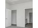 This bedroom features neutral paint, carpeted floor, and an open closet area at 7300 Legends Way, Whitestown, IN 46052