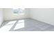 Bright bedroom with gray carpet and two large windows at 7300 Legends Way, Whitestown, IN 46052