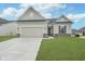 Charming single-story home with a two-car garage, well-maintained lawn, and neutral exterior paint at 7300 Legends Way, Whitestown, IN 46052