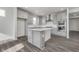 Modern kitchen featuring an island, stainless steel appliances, and sleek light gray cabinetry at 7300 Legends Way, Whitestown, IN 46052