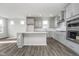 Modern kitchen featuring an island, stainless steel appliances, and sleek light gray cabinetry at 7300 Legends Way, Whitestown, IN 46052