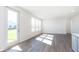 Bright living room with hardwood floors and large windows at 7300 Legends Way, Whitestown, IN 46052