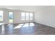 Bright living room with hardwood floors and large windows at 7300 Legends Way, Whitestown, IN 46052