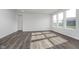 Bright, spacious living room with hard surface flooring and ample natural light from multiple windows at 7300 Legends Way, Whitestown, IN 46052