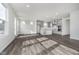 Open-concept living area with hard surface floors seamlessly transitioning to the stylish kitchen at 7300 Legends Way, Whitestown, IN 46052