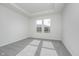 Bright main bedroom featuring plush carpeting, tray ceiling, and large window for natural light at 7300 Legends Way, Whitestown, IN 46052