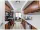 Galley kitchen with stainless steel appliances and wood cabinets at 741 Ironwood Dr, Avon, IN 46123