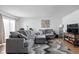 Living room featuring gray sectional sofa and wood floors at 741 Ironwood Dr, Avon, IN 46123