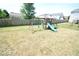 Backyard with wooden playset and large grass area at 833 Palisades Ct, Greenwood, IN 46143