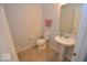Clean half-bathroom featuring tile floors, pedestal sink, and a neutral color scheme at 833 Palisades Ct, Greenwood, IN 46143