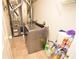 Functional laundry room with washer, furnace, storage shelves, and tile flooring at 833 Palisades Ct, Greenwood, IN 46143