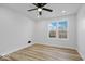Spacious bedroom featuring a ceiling fan, large window, and light flooring at 923 E Pleasant Run Pkwy S Dr, Indianapolis, IN 46203