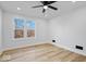 Well-lit bedroom with hardwood floors and two large windows at 923 E Pleasant Run Pkwy S Dr, Indianapolis, IN 46203
