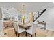 Open concept dining area with a wood table, neutral chairs and a modern light fixture at 923 E Pleasant Run Pkwy S Dr, Indianapolis, IN 46203