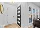 Bright entryway with a modern dark gray door and light wood floors at 923 E Pleasant Run Pkwy S Dr, Indianapolis, IN 46203