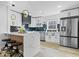 Modern kitchen with white cabinets, dark countertops, and a large island at 923 E Pleasant Run Pkwy S Dr, Indianapolis, IN 46203