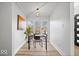 Home office featuring a glass desk, large window, and hardwood floors at 923 E Pleasant Run Pkwy S Dr, Indianapolis, IN 46203