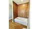 Bathroom with wood-look tile and a shower/tub combo at 929 N Bancroft St, Indianapolis, IN 46201