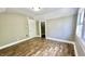 Well-lit bedroom with wood flooring, neutral walls, and ample closet space at 929 N Bancroft St, Indianapolis, IN 46201