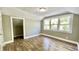 Bright bedroom featuring wood floors, neutral walls and multiple windows at 929 N Bancroft St, Indianapolis, IN 46201