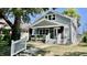 Charming gray house with a white porch and well-manicured lawn at 929 N Bancroft St, Indianapolis, IN 46201