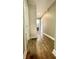 Hallway with hardwood floors and exposed brick wall at 929 N Bancroft St, Indianapolis, IN 46201