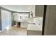 Modern kitchen with white cabinets, marble countertops, and dark gray walls at 929 N Bancroft St, Indianapolis, IN 46201