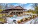Aerial view of a log home with a large deck and pool at 9600 N 500 E, Pendleton, IN 46064