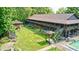 Aerial view showcasing a sprawling backyard with mature trees, garden, playset, and swimming pool at 9600 N 500 E, Pendleton, IN 46064