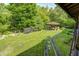 Expansive backyard features mature trees, recreational equipment, and garden beds, perfect for outdoor activities at 9600 N 500 E, Pendleton, IN 46064