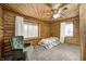 Upstairs bedroom with wood walls and a twin bed at 9600 N 500 E, Pendleton, IN 46064
